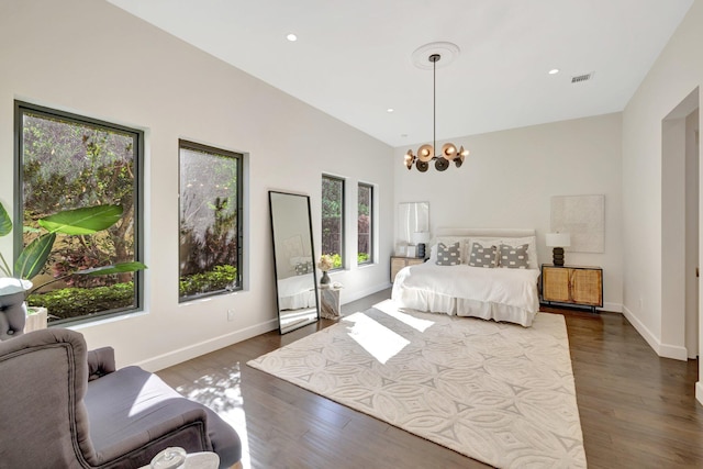 bedroom featuring visible vents, baseboards, an inviting chandelier, and dark wood finished floors