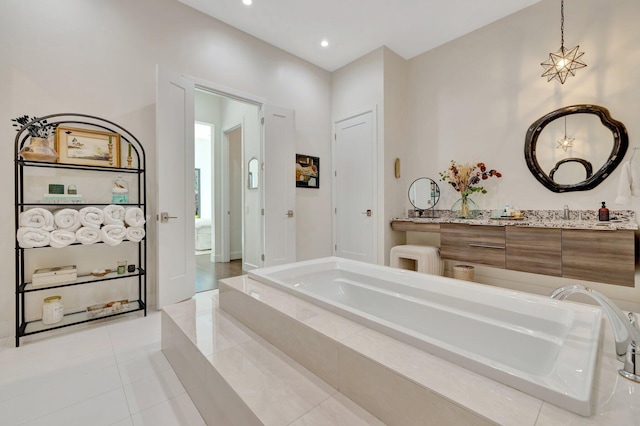 full bath featuring tile patterned flooring, recessed lighting, vanity, and a garden tub