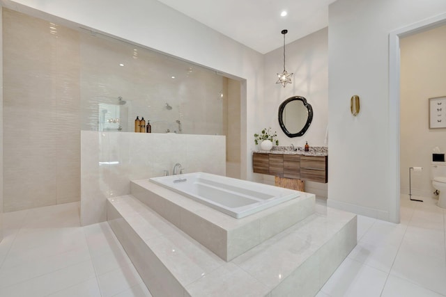 bathroom with a walk in shower, baseboards, toilet, a garden tub, and tile patterned floors