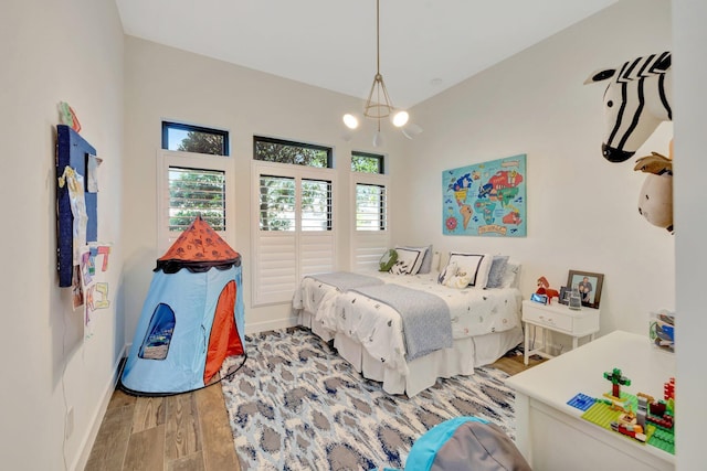 bedroom featuring wood finished floors and baseboards