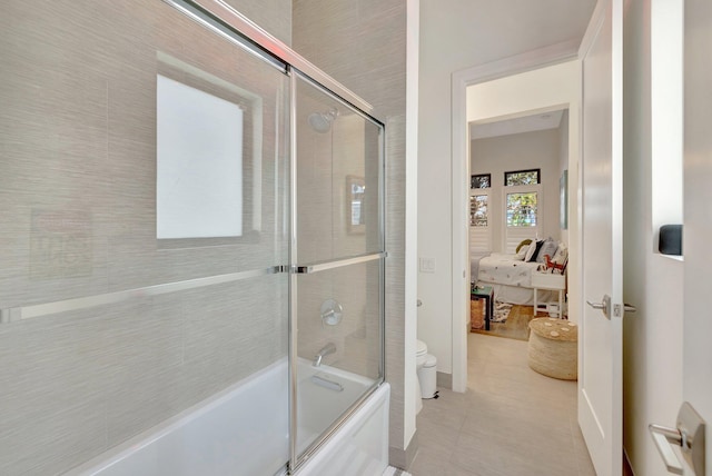 full bath with tile patterned flooring, toilet, ensuite bath, and shower / bath combination with glass door