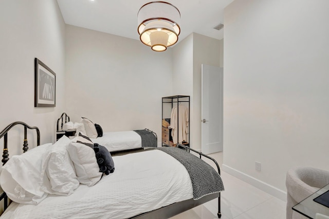 bedroom with baseboards and visible vents