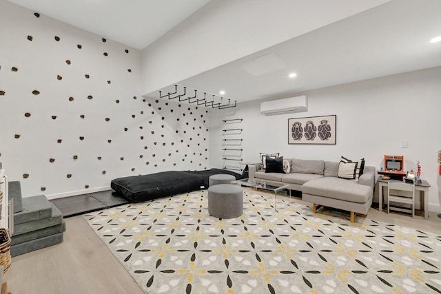 living room with a wall mounted AC, wood finished floors, recessed lighting, baseboards, and stairs