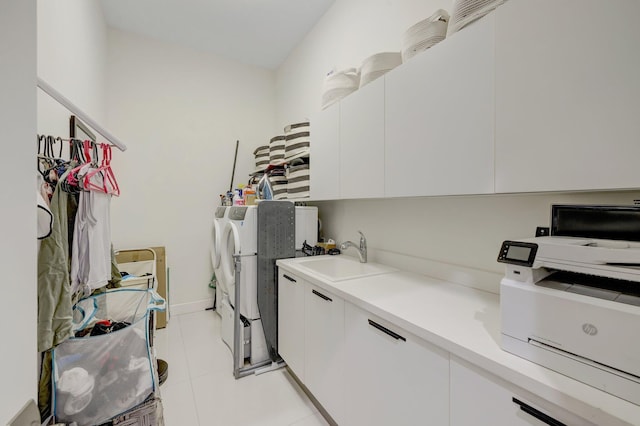 laundry area with washer and clothes dryer, light tile patterned floors, laundry area, and a sink