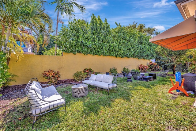 view of yard with outdoor lounge area and fence