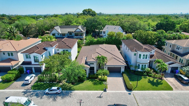 birds eye view of property featuring a wooded view and a residential view