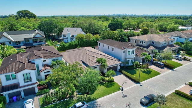 drone / aerial view featuring a residential view and a wooded view