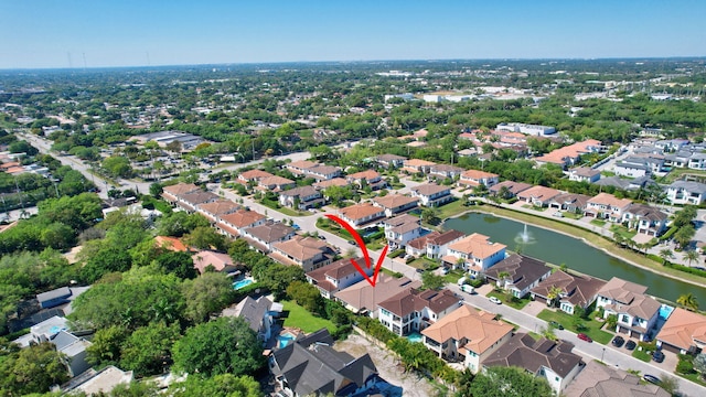 drone / aerial view with a residential view and a water view