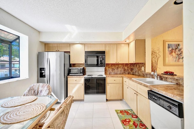 7948 La Mirada Dr, Boca Raton, FL 33433 - kitchen featuring a sink, appliances with stainless steel finishes, light brown cabinets, and a textured ceiling