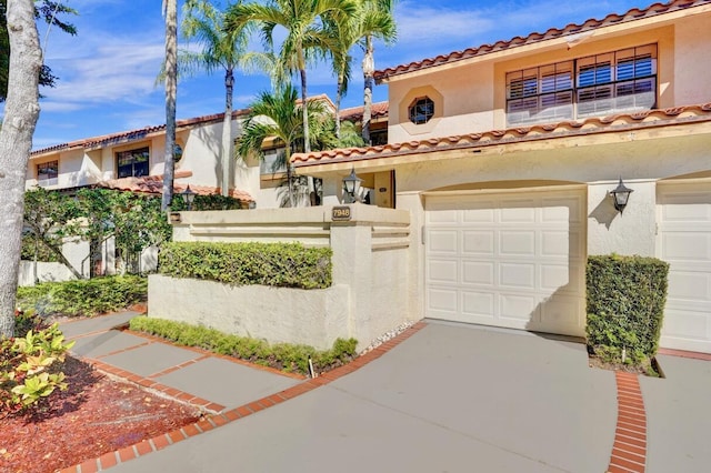 mediterranean / spanish-style home with a garage and stucco siding