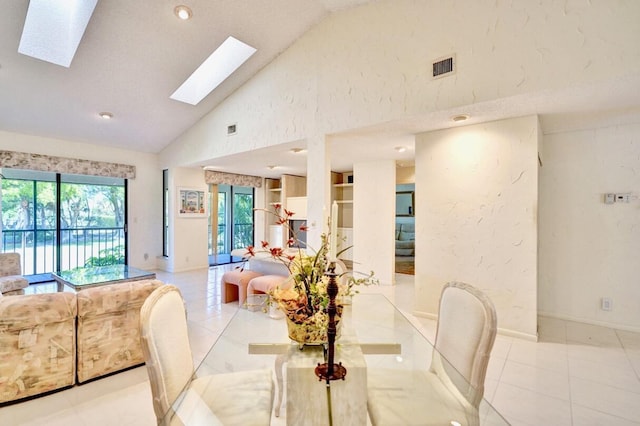 dining area with light tile patterned flooring, visible vents, a healthy amount of sunlight, and a skylight