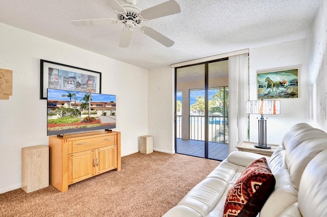 living room featuring a ceiling fan, light carpet, a textured ceiling, and floor to ceiling windows