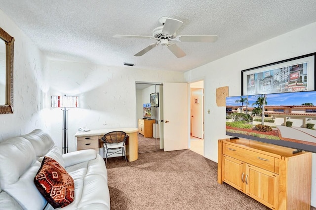 living area with light carpet, visible vents, a textured ceiling, and a textured wall