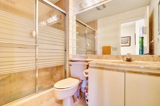 full bath featuring tile patterned floors, vanity, toilet, and a shower stall