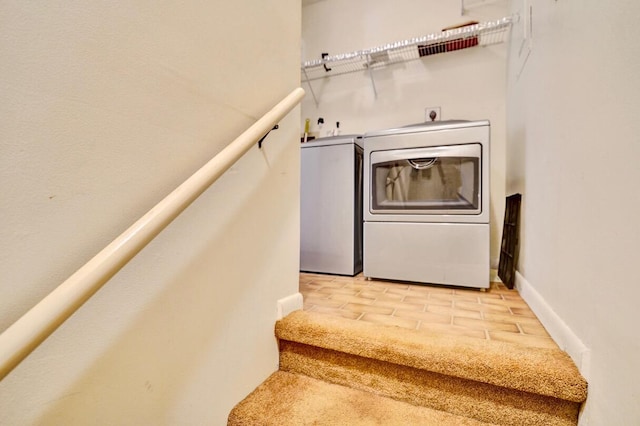 stairs featuring independent washer and dryer and baseboards