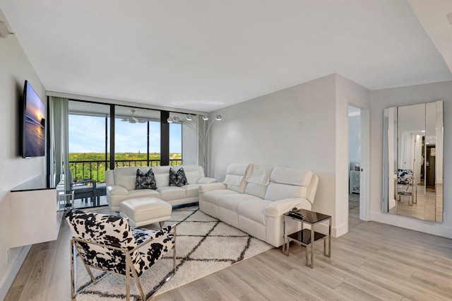 living area featuring floor to ceiling windows and wood finished floors