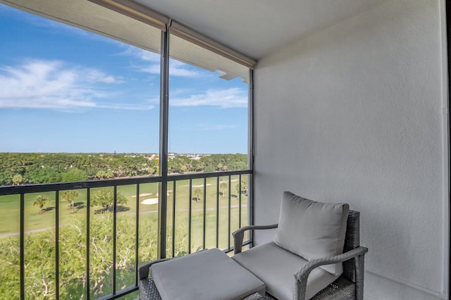 balcony featuring a wooded view