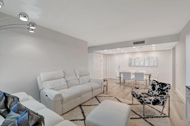 living room with visible vents and light wood-style floors