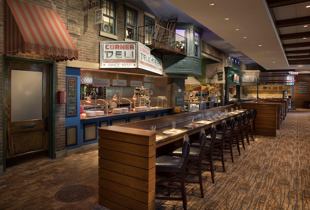 bar with a high ceiling and recessed lighting