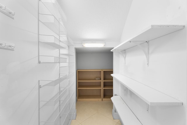 walk in closet featuring light tile patterned flooring