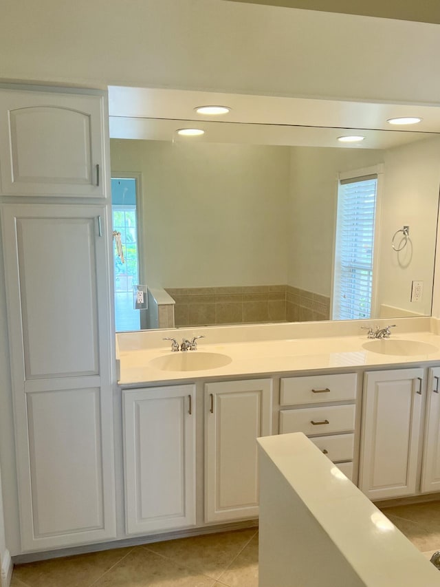 2010 NW Estuary Ct, Stuart, FL 34994 - full bath featuring double vanity, plenty of natural light, and tile patterned floors