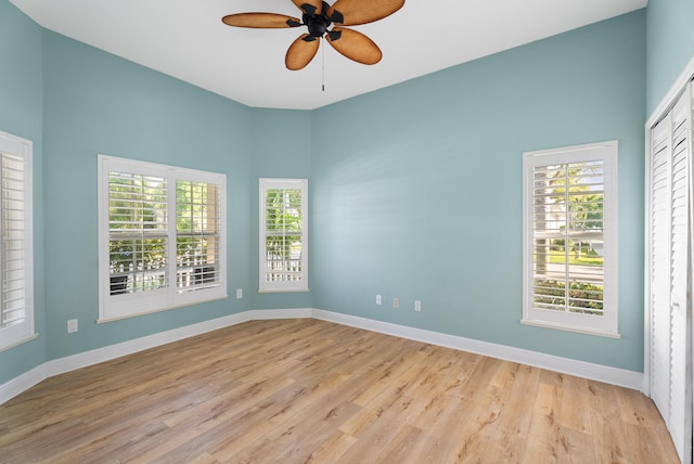 empty room with light wood-type flooring, baseboards, and ceiling fan