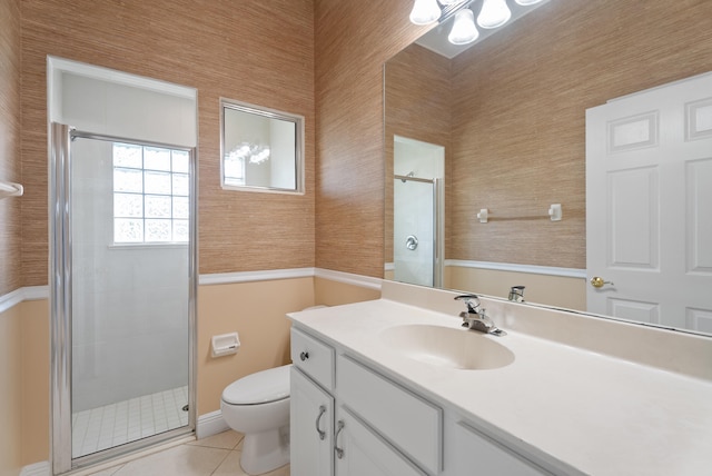 bathroom with vanity, a stall shower, tile patterned floors, toilet, and a chandelier