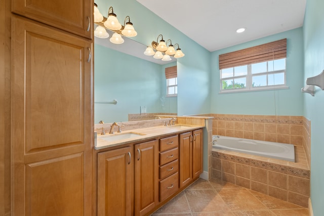 bathroom with tile patterned flooring, a garden tub, double vanity, and a sink