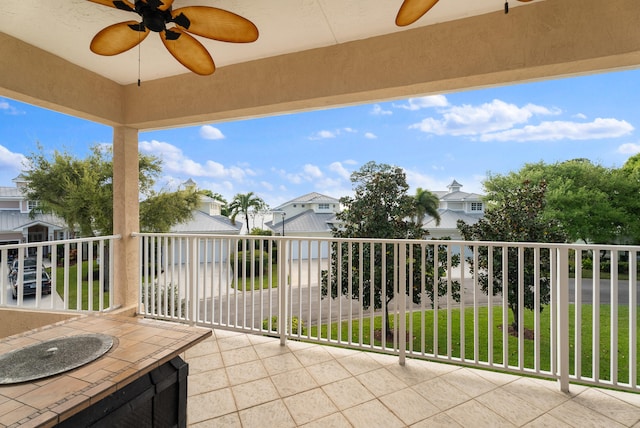 view of patio / terrace featuring a residential view, a ceiling fan, and a balcony