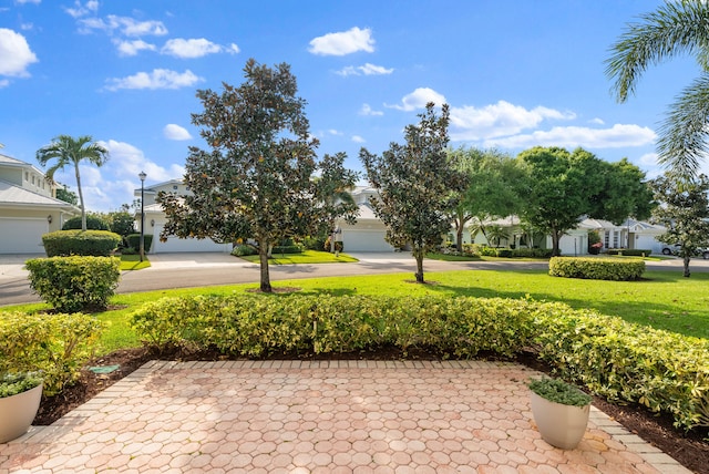 view of patio featuring a garage and driveway