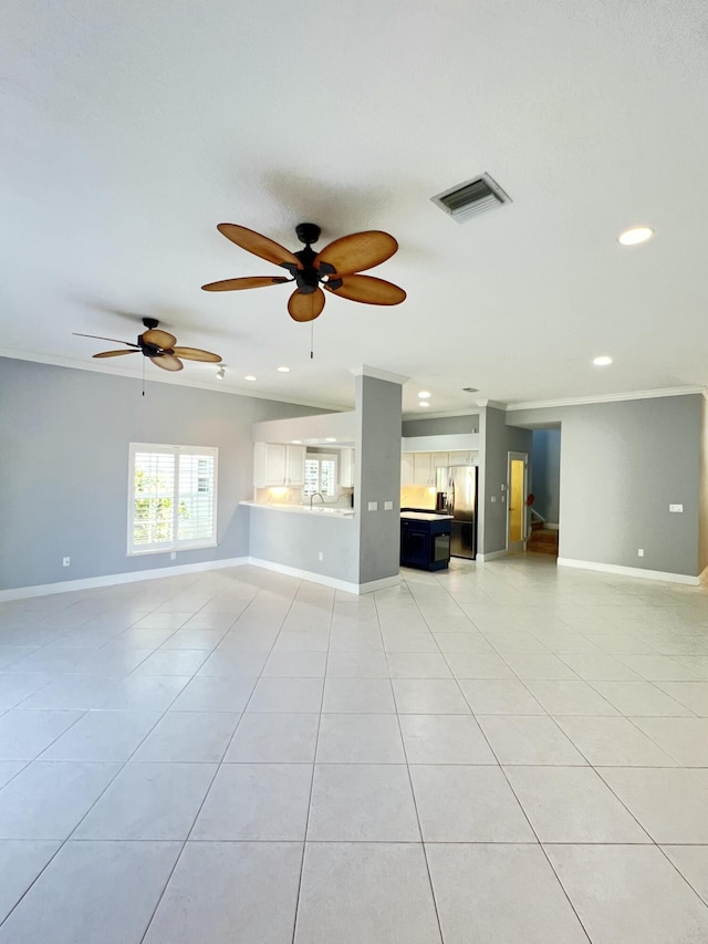 2010 NW Estuary Ct, Stuart, FL 34994 - unfurnished living room with light tile patterned floors, recessed lighting, ceiling fan, and crown molding