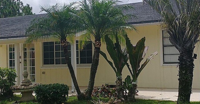 view of side of home featuring a shingled roof