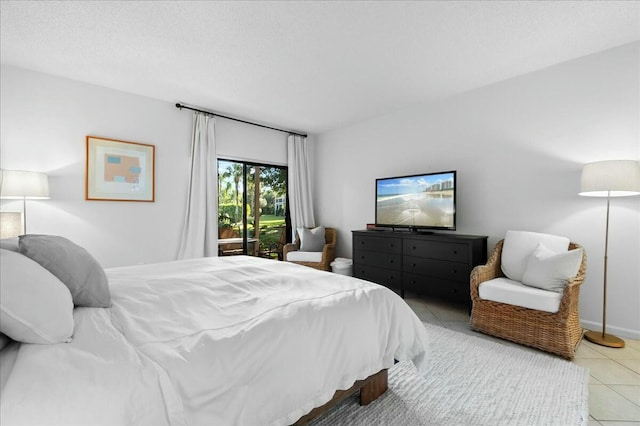 bedroom featuring light tile patterned flooring and a textured ceiling