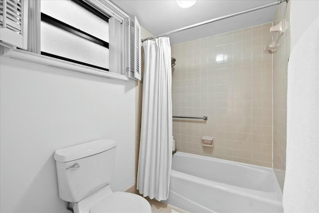 full bath with toilet and shower / bath combo with shower curtain