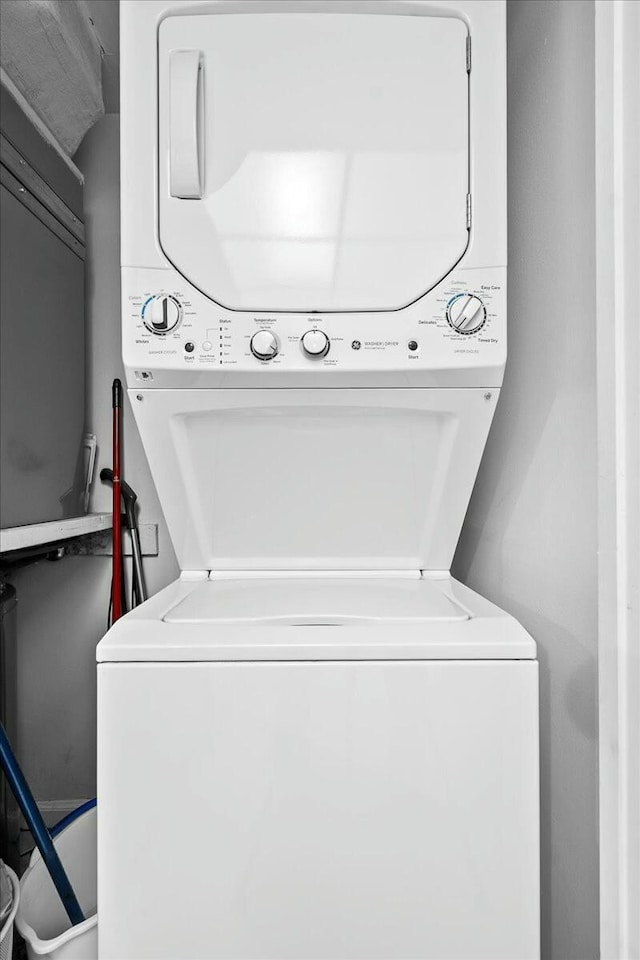 laundry room with stacked washer and dryer and laundry area