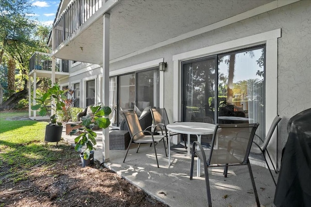 view of patio featuring a balcony