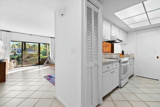 kitchen featuring light tile patterned floors, electric stove, under cabinet range hood, a textured ceiling, and white cabinetry