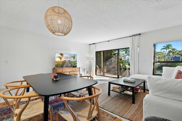 dining room with a textured ceiling and a chandelier