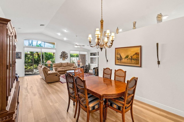 dining space with visible vents, light wood-type flooring, baseboards, and vaulted ceiling