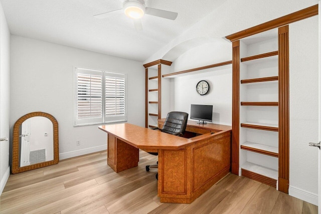 home office with a ceiling fan, light wood-style floors, and baseboards