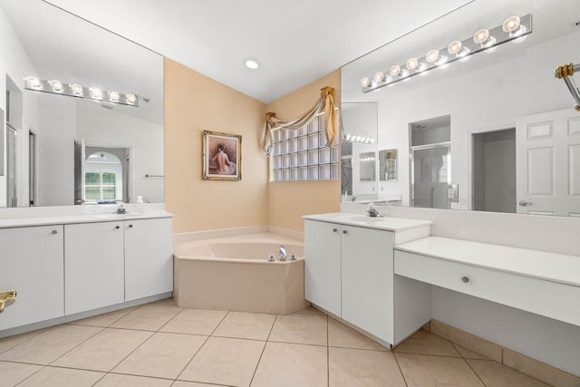 full bath featuring tile patterned flooring, a stall shower, two vanities, and a sink