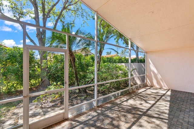 unfurnished sunroom with lofted ceiling