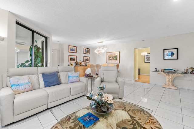 tiled living room with a chandelier and a textured ceiling