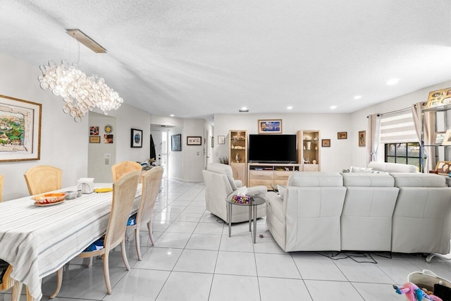 living room featuring light tile patterned floors, a textured ceiling, an inviting chandelier, and recessed lighting