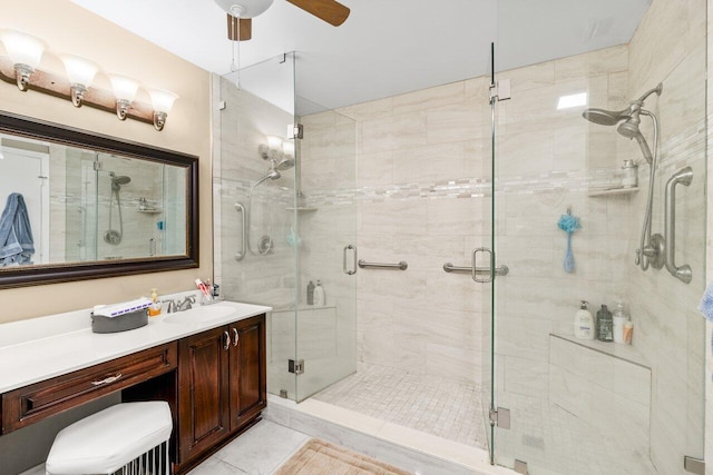 full bathroom featuring vanity, a shower stall, and ceiling fan