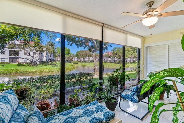 sunroom / solarium with a water view and ceiling fan