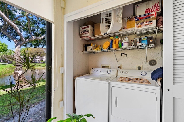 clothes washing area with independent washer and dryer and laundry area