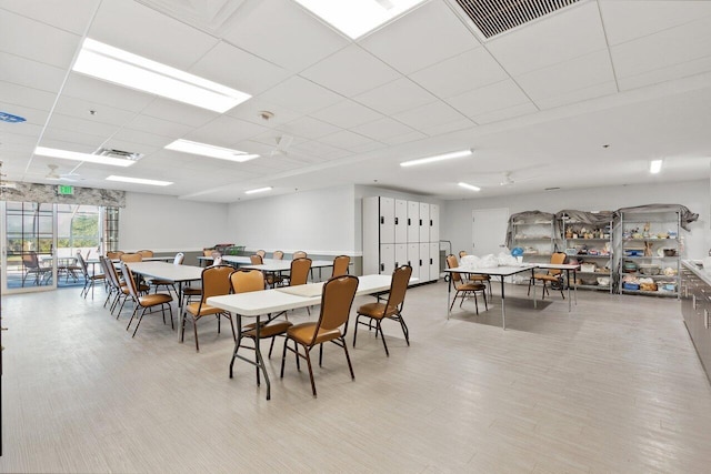 dining area featuring a paneled ceiling and visible vents