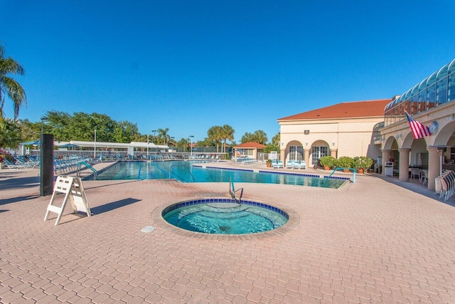 community pool with a patio area