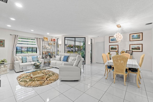 living room featuring light tile patterned floors, visible vents, a textured ceiling, and recessed lighting